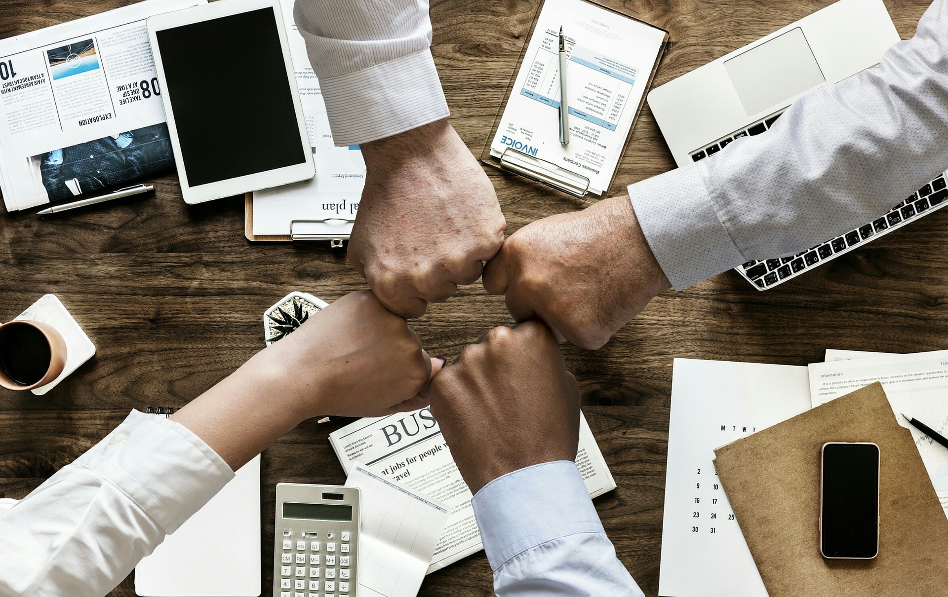 four people fistbumping